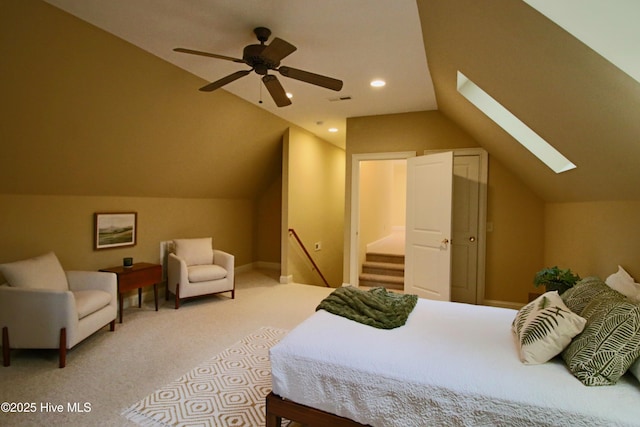carpeted bedroom featuring recessed lighting, lofted ceiling with skylight, a ceiling fan, visible vents, and baseboards