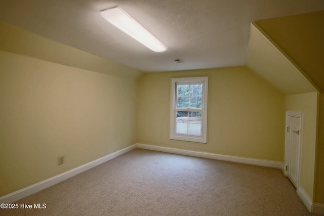 bonus room featuring baseboards, carpet flooring, and vaulted ceiling