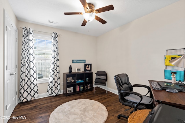 office with baseboards, visible vents, wood finished floors, and a ceiling fan