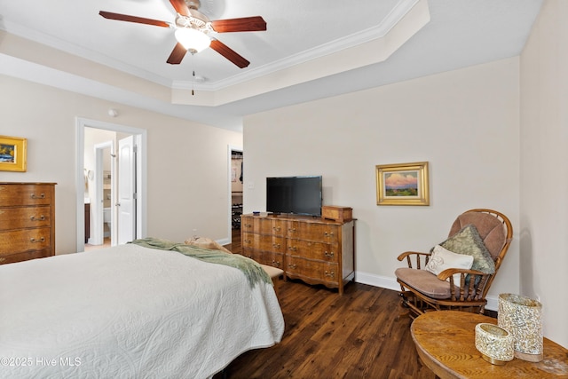 bedroom featuring crown molding, a ceiling fan, a raised ceiling, wood finished floors, and baseboards