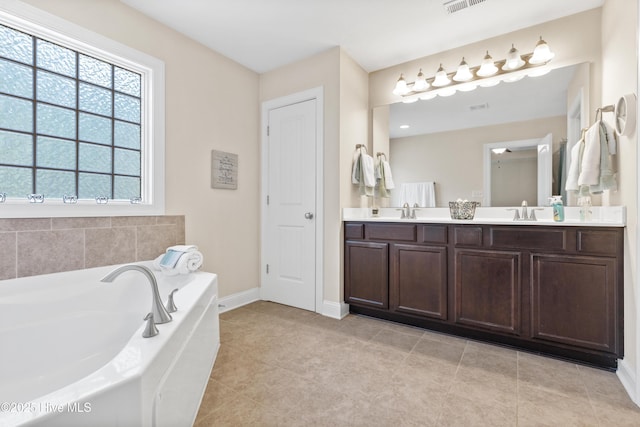 full bath with double vanity, a sink, a garden tub, and tile patterned floors