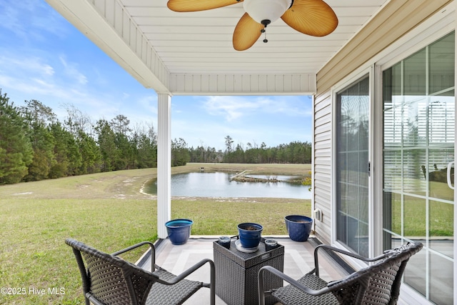 view of patio featuring a water view and ceiling fan