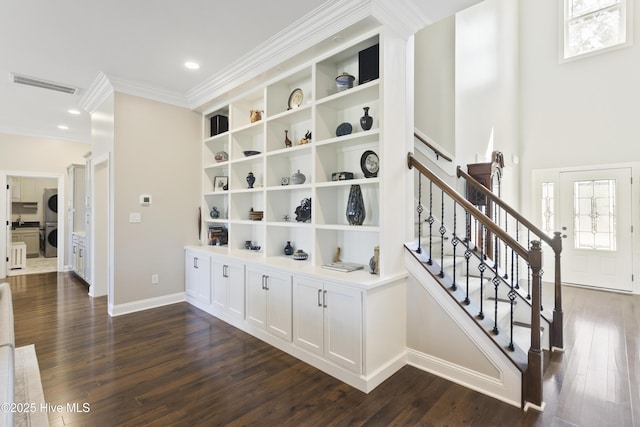 hall with crown molding, stairway, baseboards, dark wood finished floors, and visible vents
