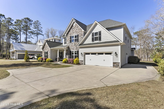 view of front of property with stone siding, driveway, and an attached garage