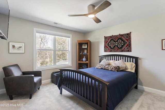 carpeted bedroom with a ceiling fan, baseboards, and visible vents