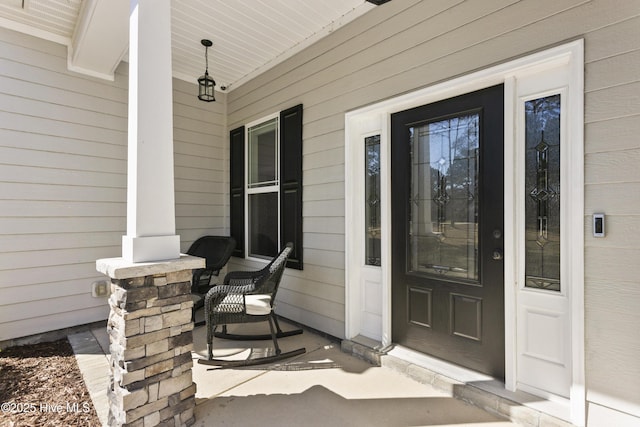 view of exterior entry with covered porch