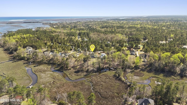 aerial view with a water view and a wooded view