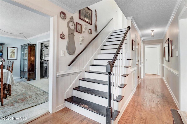 103 Roundtree Ln, Goldsboro, NC 27530 - stairway featuring a textured ceiling, wood finished floors, and ornamental molding