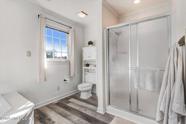 103 Roundtree Ln, Goldsboro, NC 27530 - bathroom featuring ornamental molding, wood finished floors, a shower stall, toilet, and baseboards