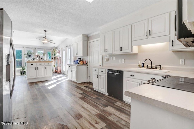 103 Roundtree Ln, Goldsboro, NC 27530 - kitchen with appliances with stainless steel finishes, a sink, dark wood-style flooring, white cabinets, and a textured ceiling