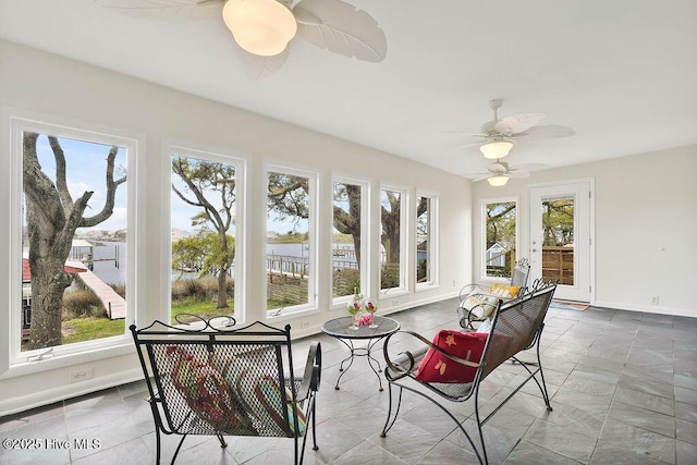 sunroom / solarium with baseboards and a healthy amount of sunlight