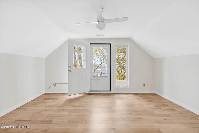 bonus room with ceiling fan, baseboards, vaulted ceiling, and wood finished floors