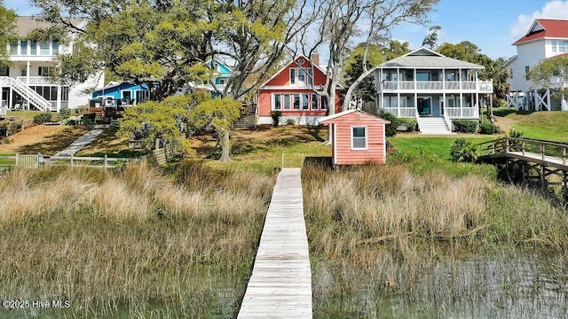 rear view of house featuring stairway and a sunroom