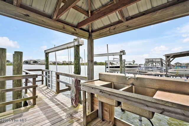 view of dock with boat lift and a water view