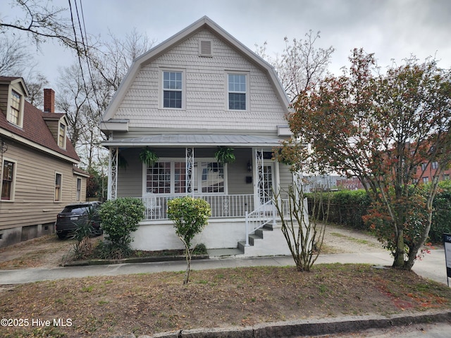 dutch colonial with covered porch and a gambrel roof