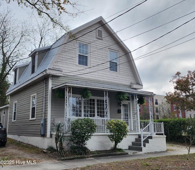 view of front of home with a gambrel roof and a porch