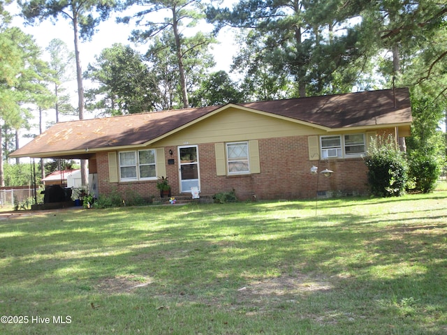 single story home with brick siding, an attached carport, crawl space, and a front lawn