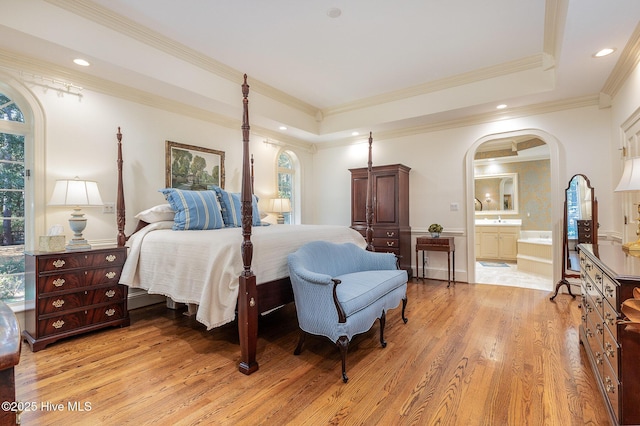 bedroom with arched walkways, multiple windows, and ornamental molding