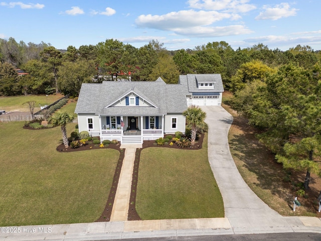 114 Sundance Cir, Hampstead, NC 28443 - view of front facade featuring a porch, a front yard, roof with shingles, and concrete driveway