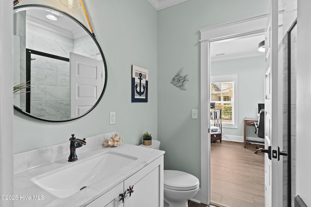 114 Sundance Cir, Hampstead, NC 28443 - bathroom with crown molding, vanity, toilet, wood finished floors, and tiled shower