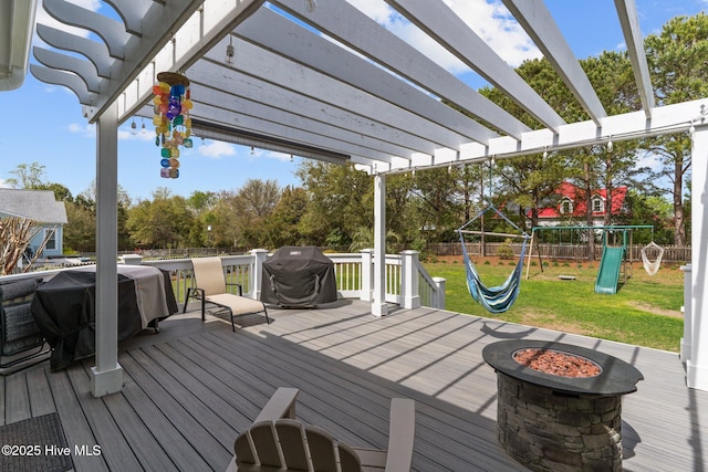 114 Sundance Cir, Hampstead, NC 28443 - wooden terrace with a playground, a fire pit, a pergola, and a grill