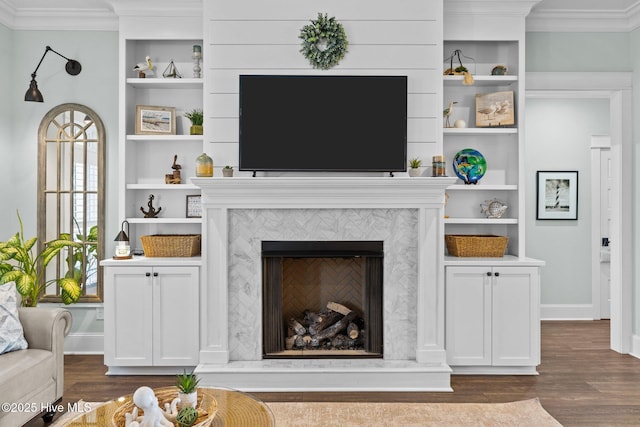 114 Sundance Cir, Hampstead, NC 28443 - living room with dark wood-type flooring, ornamental molding, a tiled fireplace, built in features, and baseboards