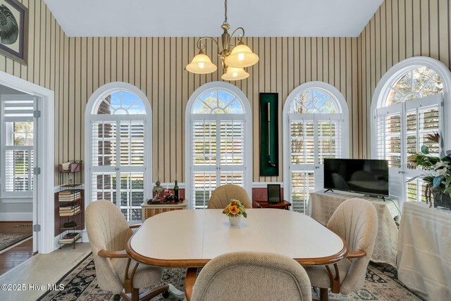 kitchen featuring crown molding, a sink, white cabinetry, light stone countertops, and appliances with stainless steel finishes