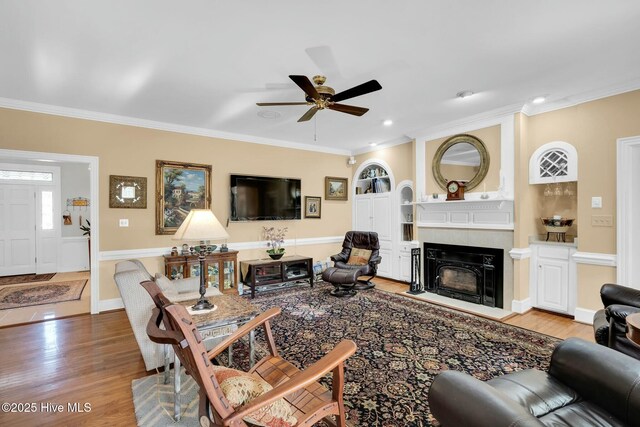 interior space featuring crown molding, wood finished floors, and ceiling fan