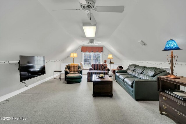 living area with carpet floors, baseboards, lofted ceiling, and ceiling fan