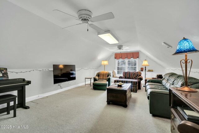 carpeted living area with a ceiling fan, baseboards, and vaulted ceiling