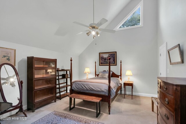 carpeted bedroom featuring a ceiling fan and high vaulted ceiling