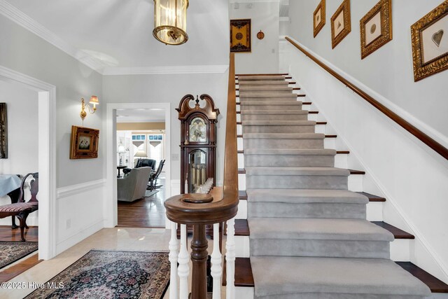 dining area with a notable chandelier, crown molding, french doors, wood finished floors, and baseboards