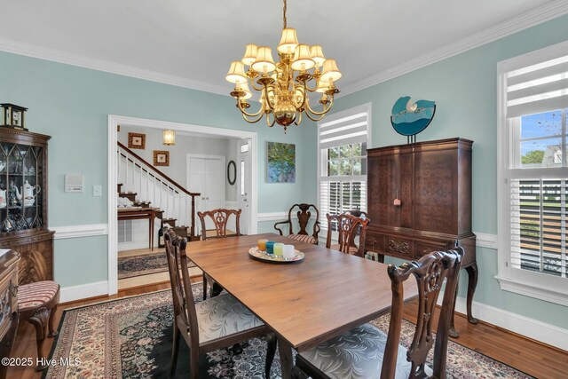 entrance foyer featuring tile patterned flooring, ornamental molding, and stairway