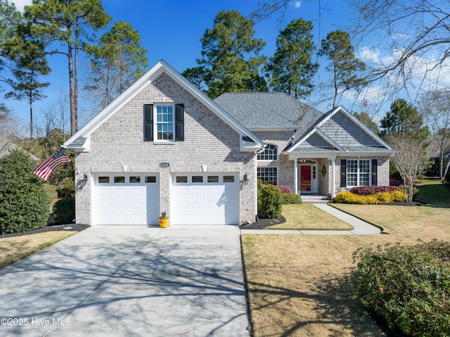 view of front of house featuring brick siding, a garage, a front lawn, and concrete driveway