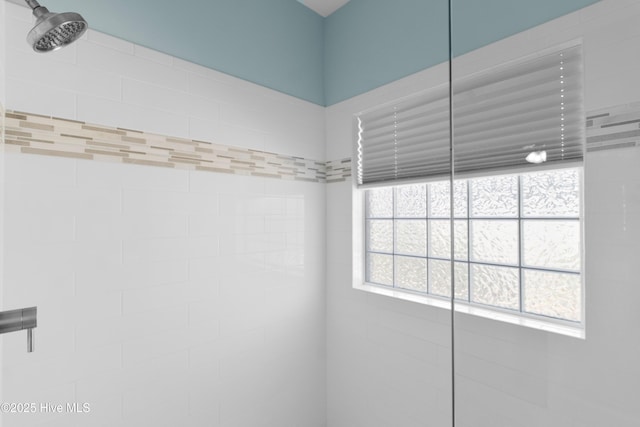 bathroom with tiled shower