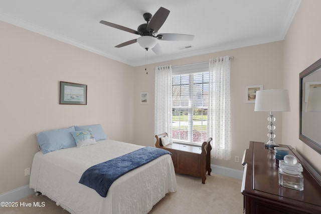 bedroom with light colored carpet, ornamental molding, baseboards, visible vents, and a ceiling fan
