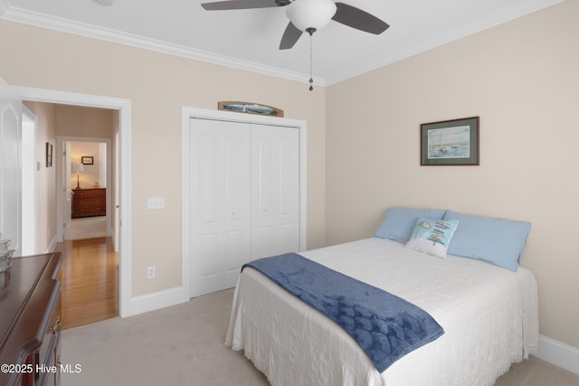 bedroom featuring crown molding, a closet, and baseboards