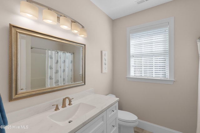 bathroom featuring a shower with curtain, vanity, toilet, baseboards, and visible vents