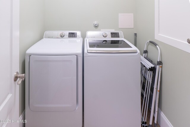 washroom with washing machine and clothes dryer and laundry area
