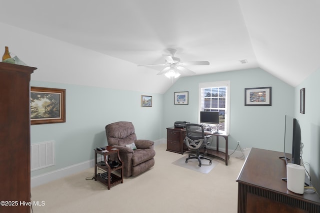 carpeted home office with a ceiling fan, baseboards, vaulted ceiling, and visible vents