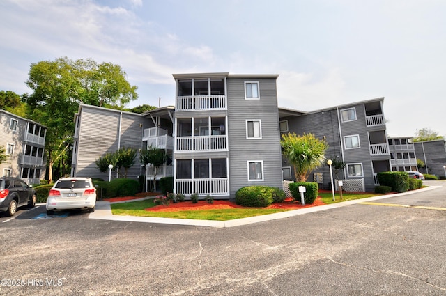 10170 Beach Dr SW Unit 305, Calabash, NC 28467 - view of property featuring uncovered parking