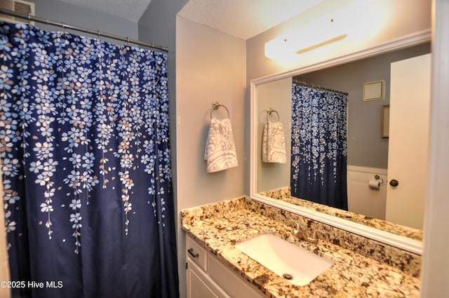 10170 Beach Dr SW Unit 305, Calabash, NC 28467 - bathroom featuring vanity, a shower with shower curtain, and a textured ceiling