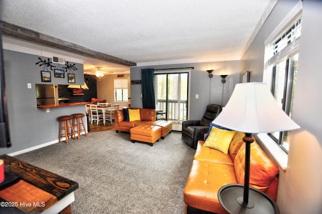 10170 Beach Dr SW Unit 305, Calabash, NC 28467 - carpeted living area featuring baseboards, a textured ceiling, and a ceiling fan