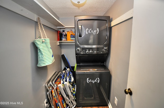 10170 Beach Dr SW Unit 305, Calabash, NC 28467 - laundry area with stacked washing machine and dryer and a textured ceiling
