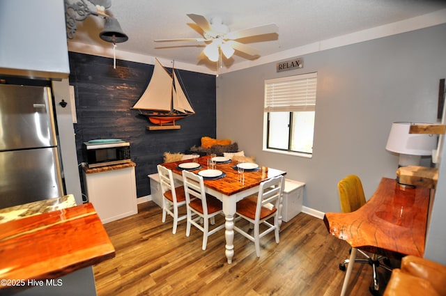 10170 Beach Dr SW Unit 305, Calabash, NC 28467 - dining area with baseboards, ceiling fan, and wood finished floors