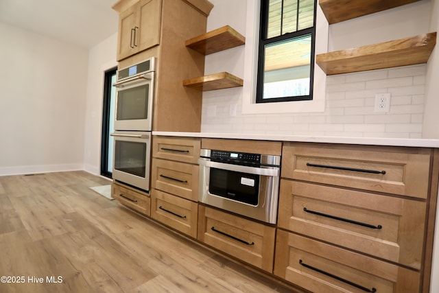 130 Gails Rd, West End, NC 27376 - kitchen with open shelves, double oven, backsplash, and light wood finished floors