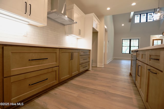 130 Gails Rd, West End, NC 27376 - kitchen with wall chimney exhaust hood, backsplash, light wood-style flooring, hanging light fixtures, and recessed lighting