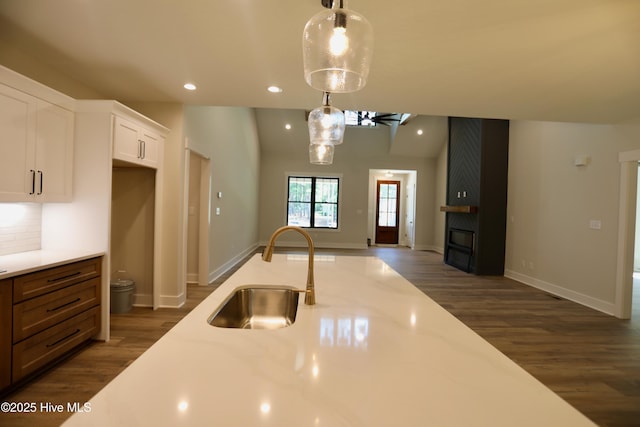 130 Gails Rd, West End, NC 27376 - kitchen with dark wood-type flooring, white cabinetry, decorative light fixtures, open floor plan, and recessed lighting