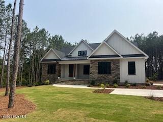 130 Gails Rd, West End, NC 27376 - craftsman house featuring a front yard, covered porch, and stone siding