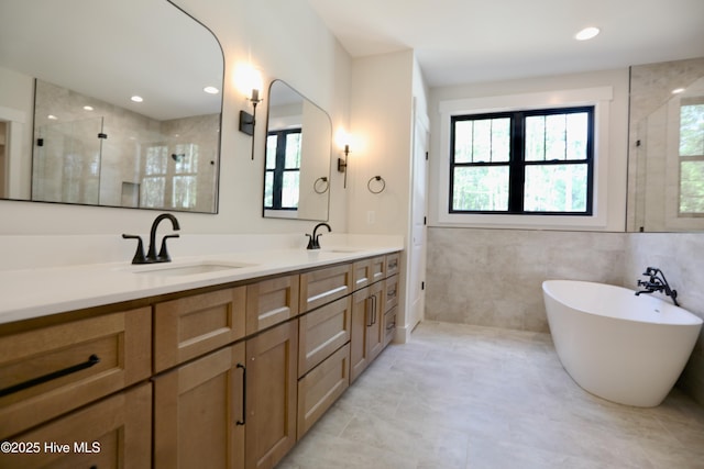 130 Gails Rd, West End, NC 27376 - bathroom with a stall shower, plenty of natural light, double vanity, and tile walls